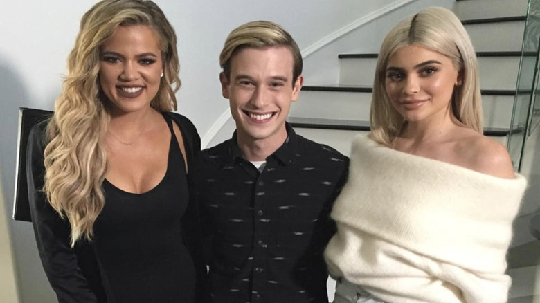 Khloe Kardashian ,Tyler Henry, and Kylie Jenner pose by staircase