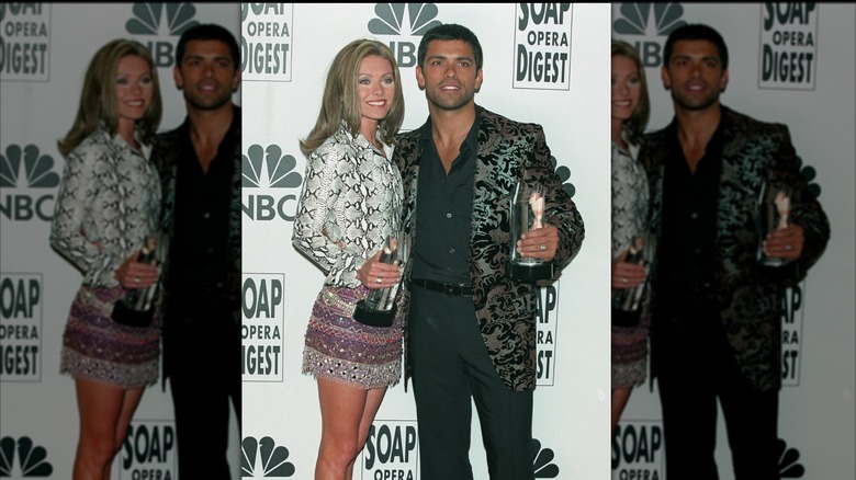Kelly Ripa and Mark Consuelos posing with awards in 2000