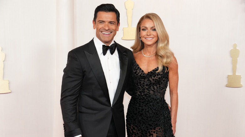 Kelly Ripa and Mark Consuelos posing in 2024