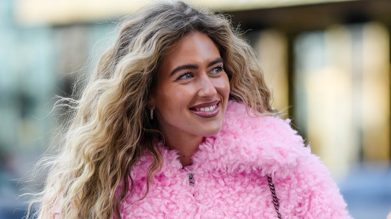 woman with dirty blond curls walking