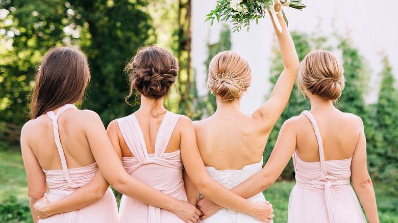 bride and bridesmaids facing away from camera