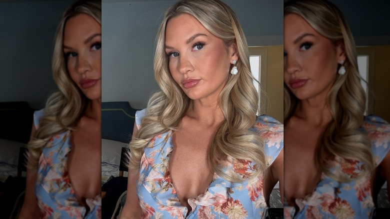 Molly O'Connell takes a selfie in a floral dress