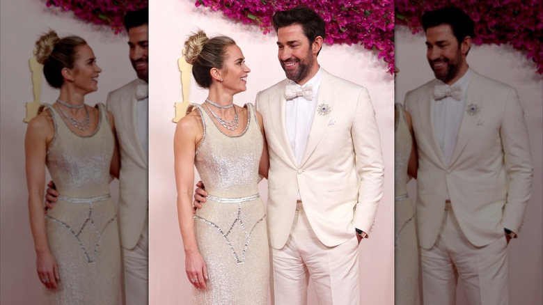 Emily Blunt and John Krasinski at the Oscars red carpet smiling at each other