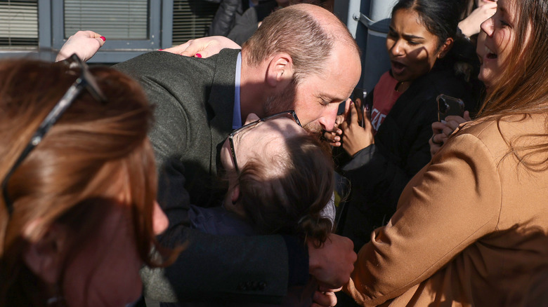 Prince William hugging a fan