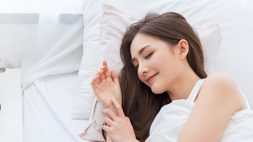 Woman smiling in her sleep