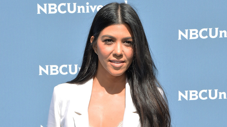 Kourtney Kardashian with a middle part