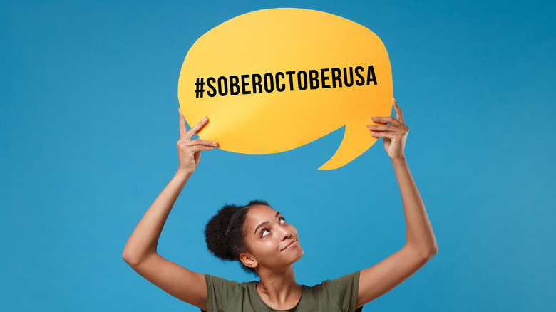 woman holding up #soberoctoberusa sign