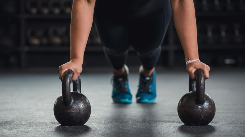 Woman with two kettlebell weights