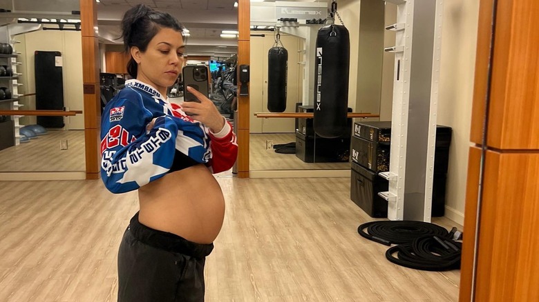 Kourtney Kardashian taking a selfie of her pregnant belly