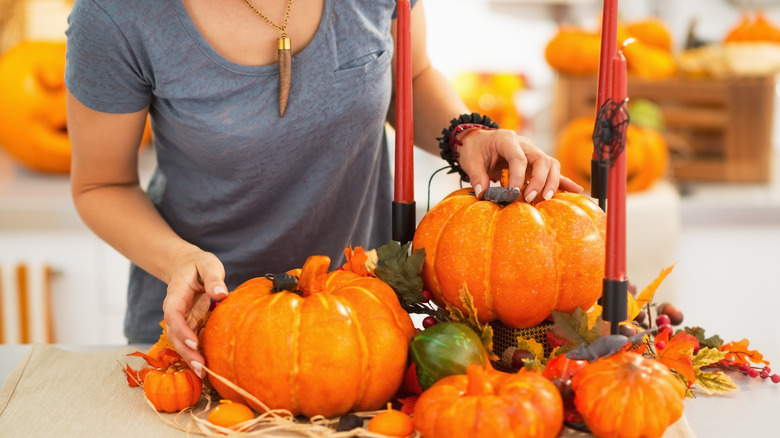 A person decorating for fall