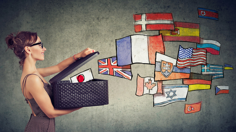 Woman opening box with international flags 
