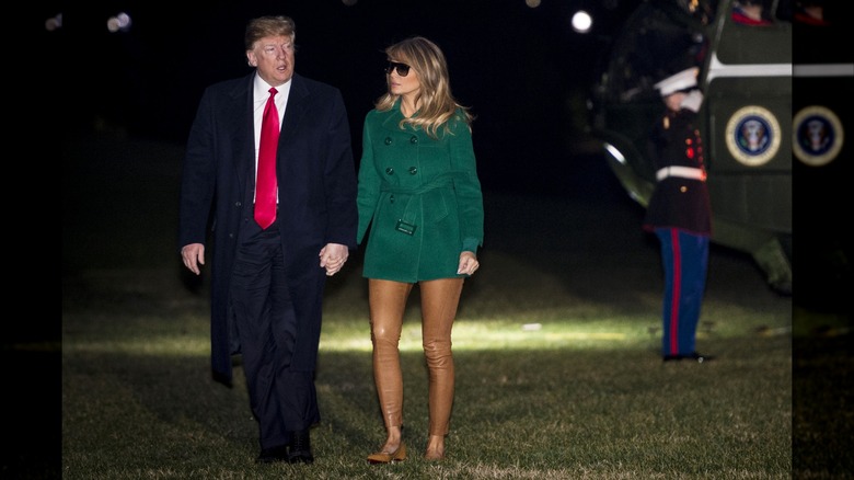 Donald Trump and Melania Trump walking and holding hands