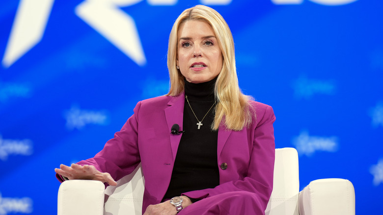 Pam Bondi talking in a purple suit
