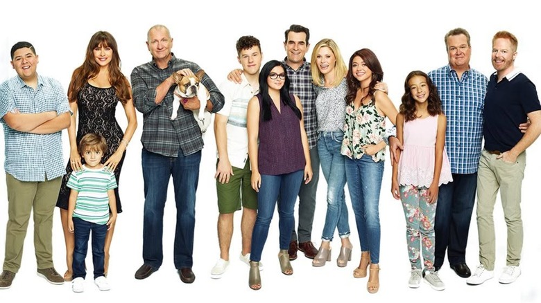 The cast of Modern Family posing and smiling for photo.