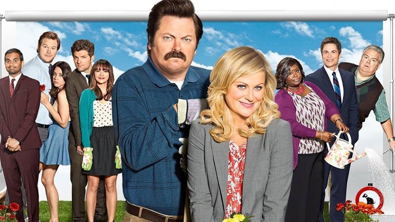 The cast of Parks and Recreation smiling and posing in promotional materials.