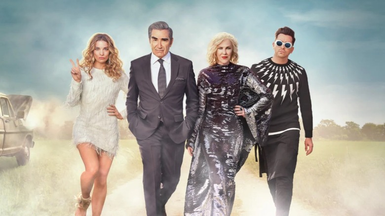 The cast of Schitt's Creek posing in promotional poster.