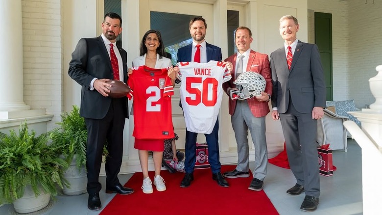 Usha Vance and J.D. Vance pose for a photo with members of the Ohio State football team (2025)