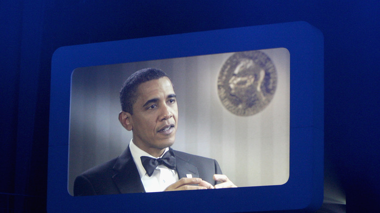 Barack Obama speaks on a screen at the Nobel Peace Prize Concert at Oslo Spektrum on December 11, 2009.