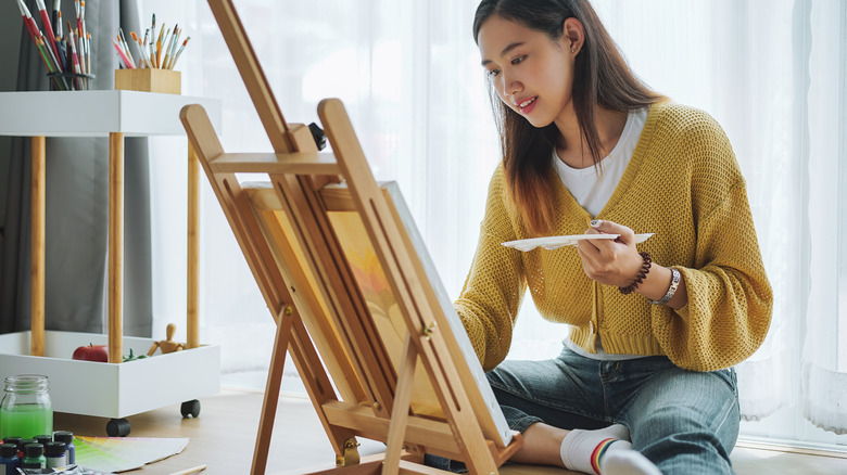 woman painting on an easel