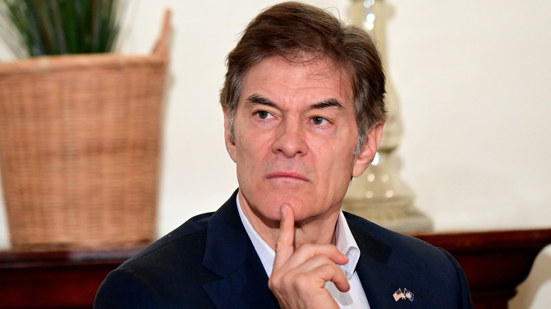 Dr. Mehmet Oz frowning with chin resting on one finger