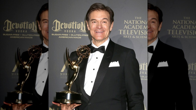 Dr. Oz in tuxedo holding Emmy