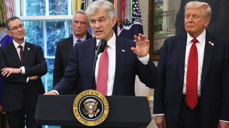 Dr. Oz at Oval Office podium hand raised Donald Trump
