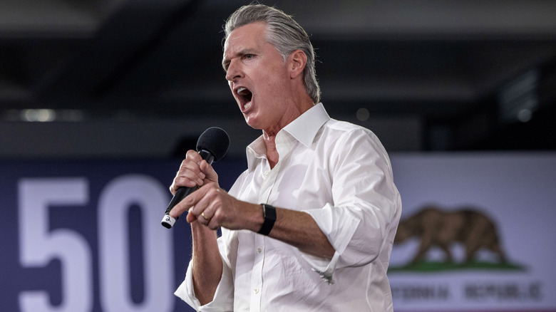 Gavin Newsom delivering an impassioned speech in a white shirt