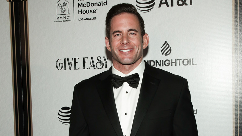 Tarek El Moussa smiling in a tuxedo at an event