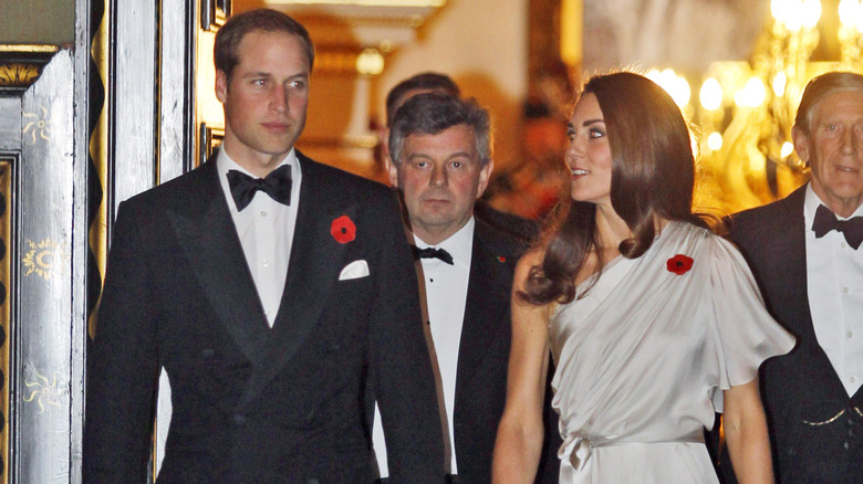 Princess Catherine and Prince William walking together in their finery in 2009
