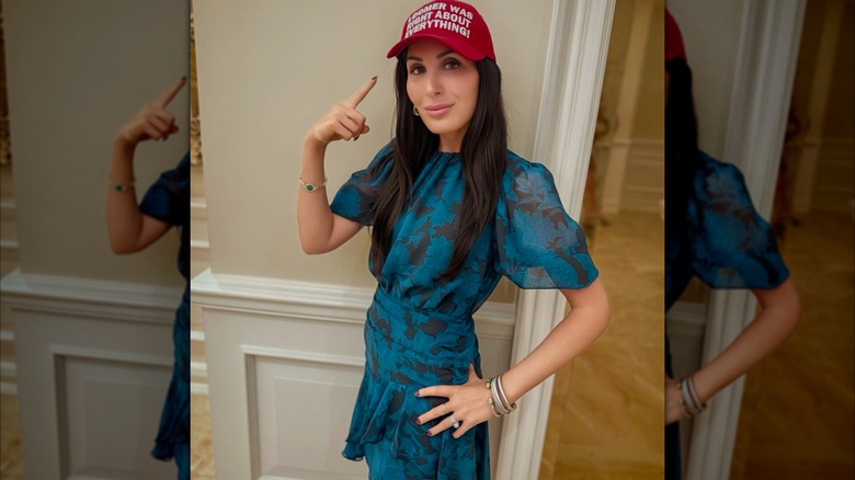 Laura Loomer pointing at her "Loomer was right about everything" hat