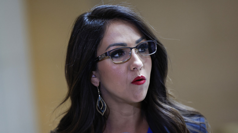 Lauren Boebert speaking at a briefing with the U.S. secret service while wearing a black jacket and blue shirt.