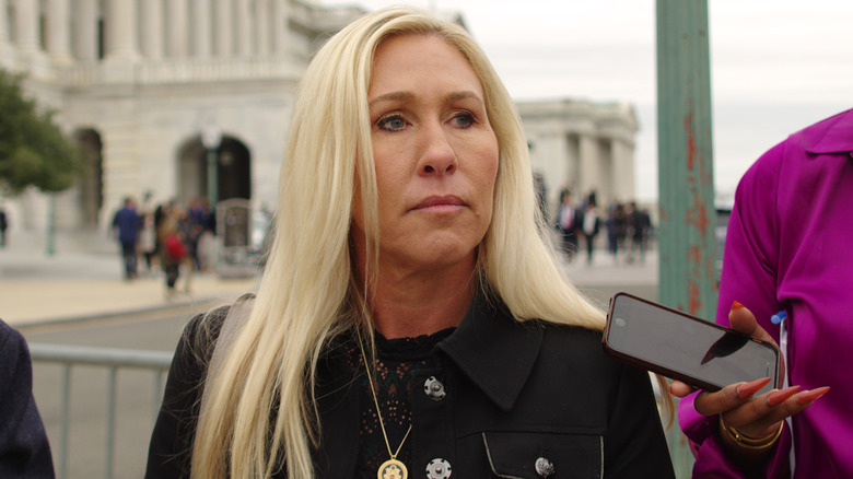 Marjorie Taylor Greene answering questions in a black jacket