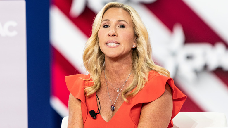 Marjorie Taylor Greene gurning in a red dress