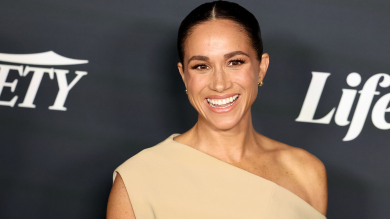 Meghan Markle laughing at the camera