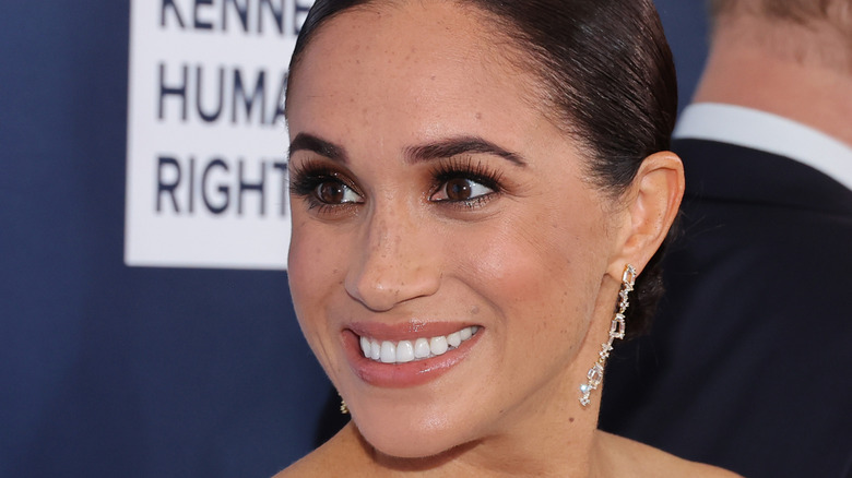 Meghan Markle smiling at the camera