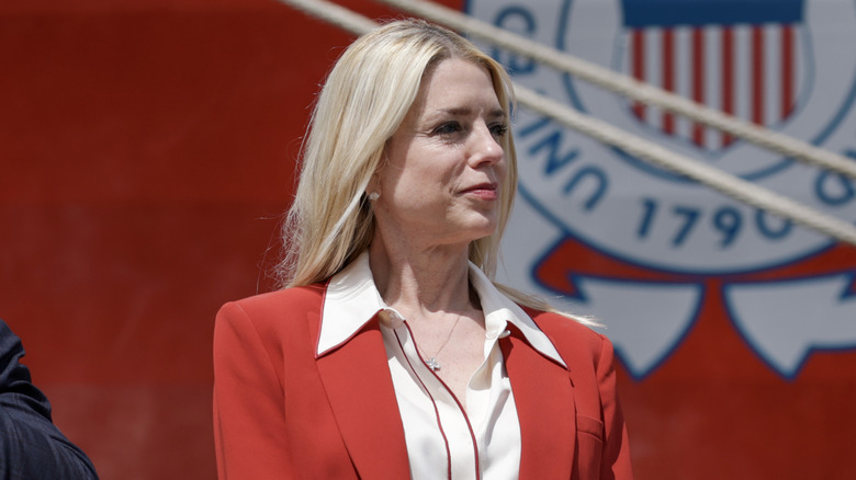Pam Bondi looking stoic in red blazer