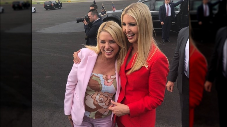 Pam Bondi smiling and embracing Ivanka Trump