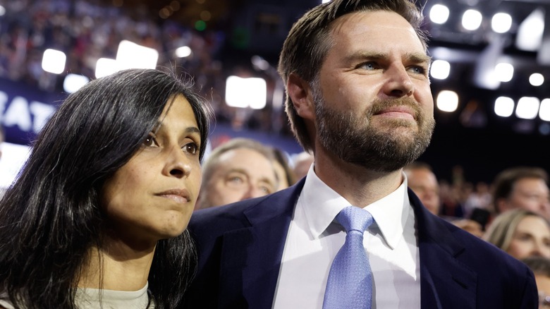 Usha Vance wearing a light brown shirt next to JD Vance who's wearing a suit and blue tie at the Republican National Convention.