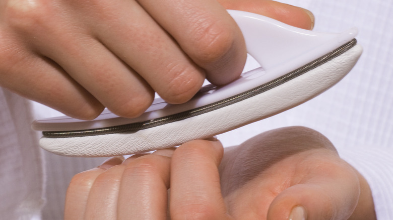 Hands buffing nails