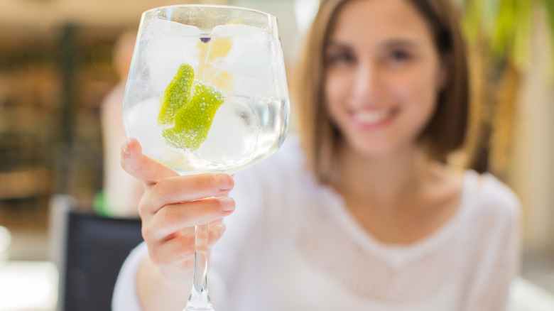 Woman holding a gin and tonic