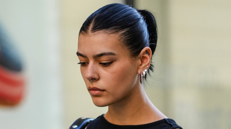 woman with short hair in high ponytail