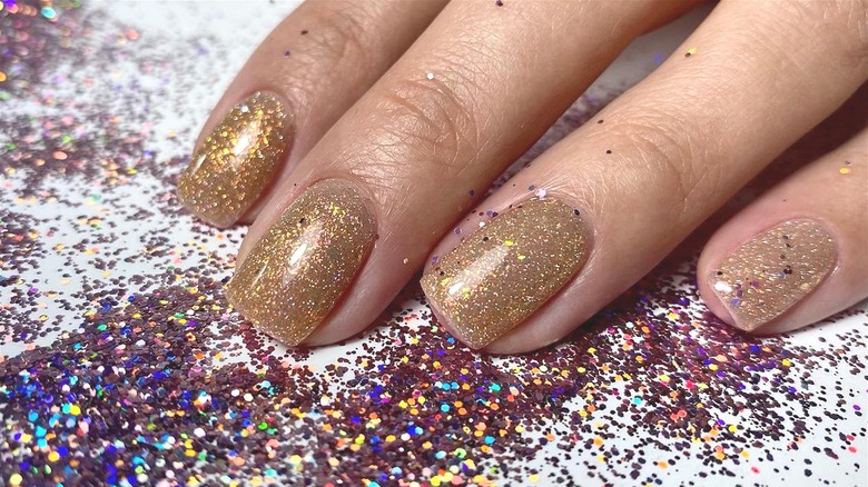 glitter nails with glitter around hand