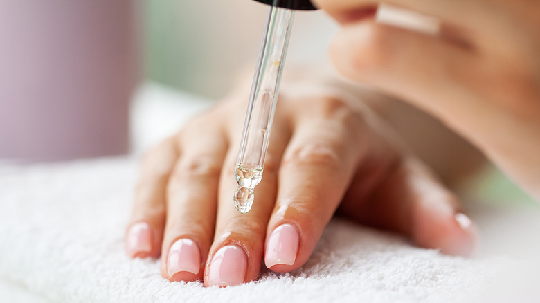 Woman moisturizing her cuticles