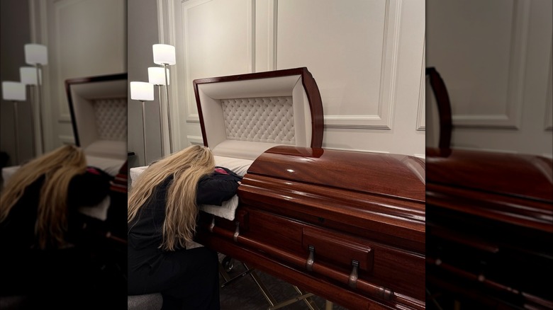 Erika Kirk leaning over Charlie Kirk's casket