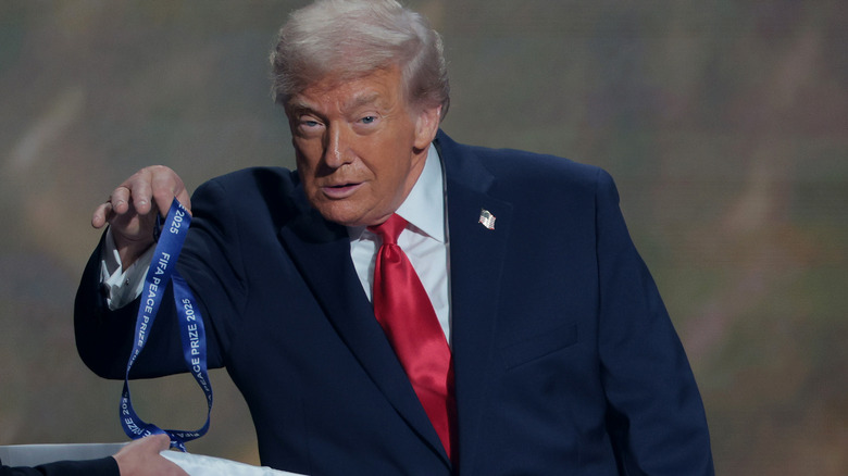 Donald Trump picking up a medal