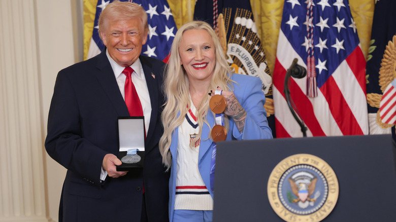 Donald Trump posing with his Order of Ikkos medal next to Olympic bobsled champion Kaillie Humphries