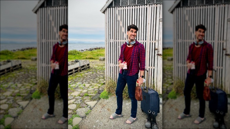 Brian Patrick Flynn posing with his luggage in Greenland
