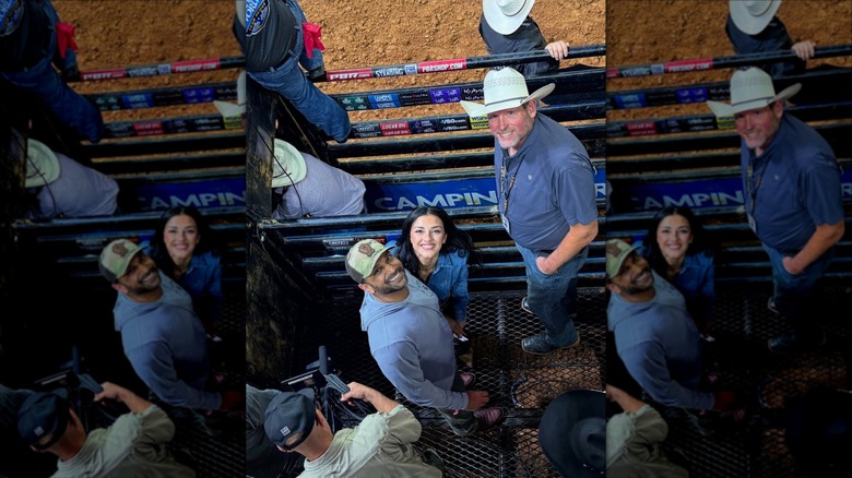 Kash Patel and Alexis Wilkins smile up at a camera in a caged area.