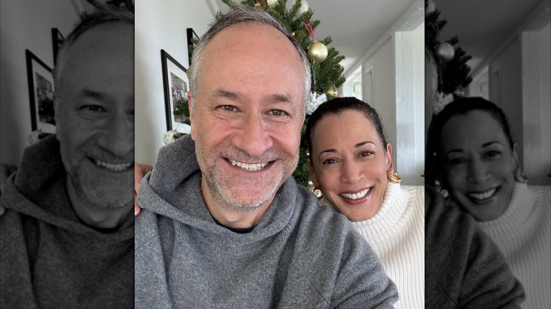 Doug Emhoff and Kamala Harris smiling in front of a Christmas tree