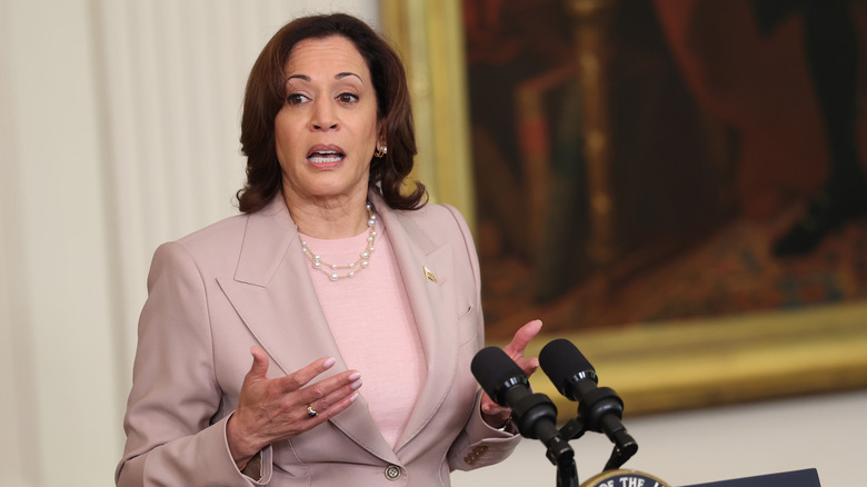 Kamala Harris speaking behind a podium